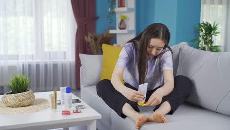 Young-Asian-girl-applying-cream-to-her-feet-and-ankles.